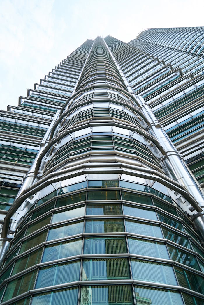 Stunning low angle perspective of the iconic Petronas Twin Towers against a clear sky.